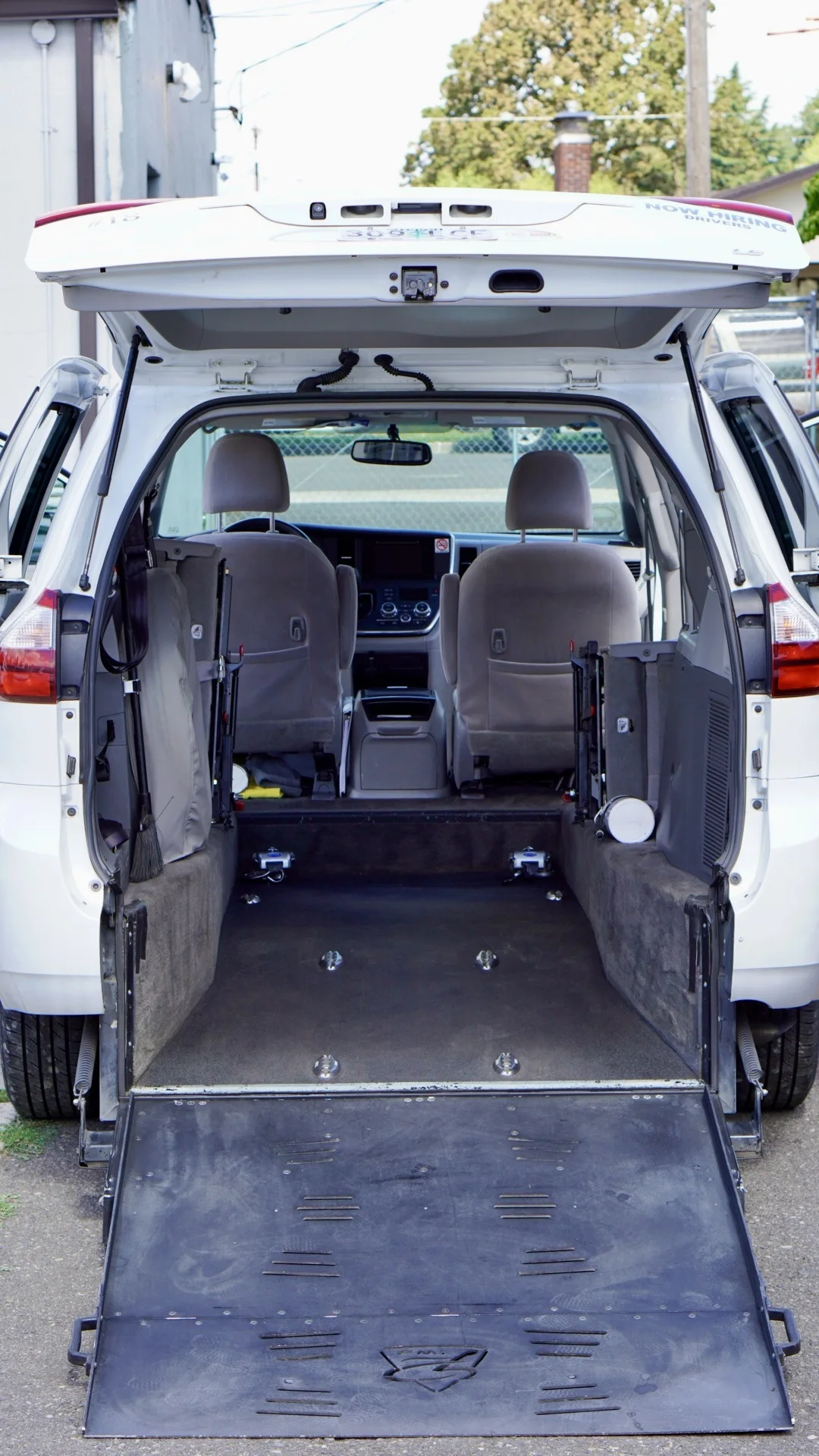 Rear entry of a wheelchair-accessible van with its ramp fully deployed