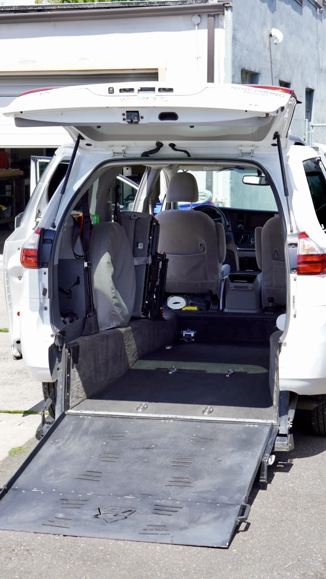 Wheelchair-accessible van viewed from the deployed rear-entry ramp