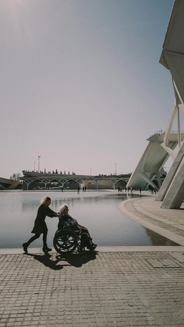 Woman with wheelchair by water